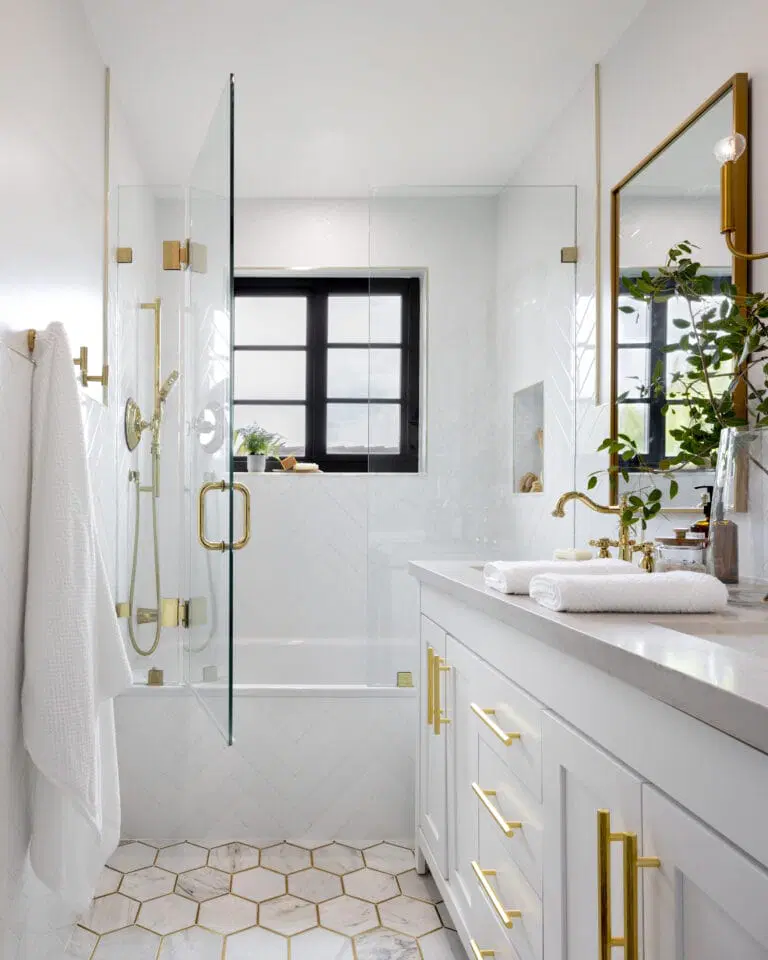 Bathroom renovation with gold fixtures and glass shower